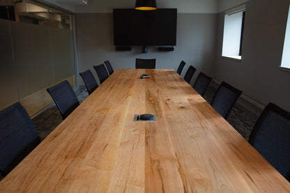 Light wood conference table with electronics bay cut out