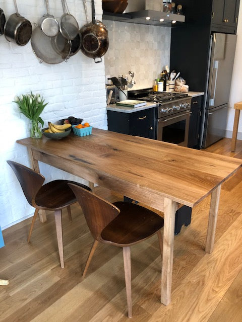 Small light colored wooden dining table