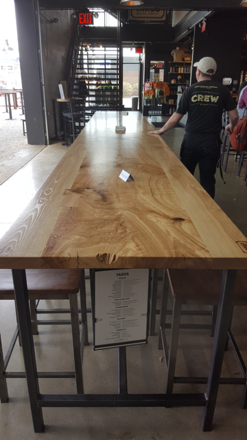 Long wooden restaurant table with metal legs