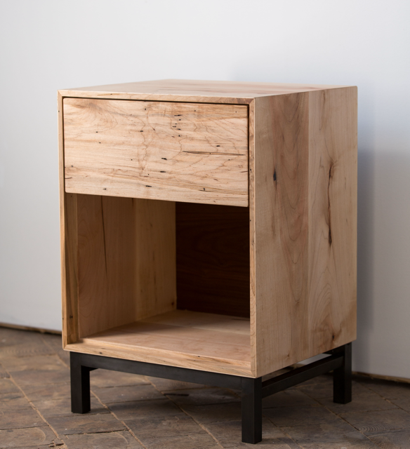 Light colored wooden side table with drawer